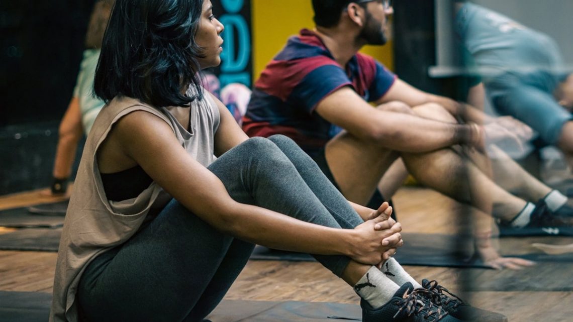 a group of people sitting on yoga mats