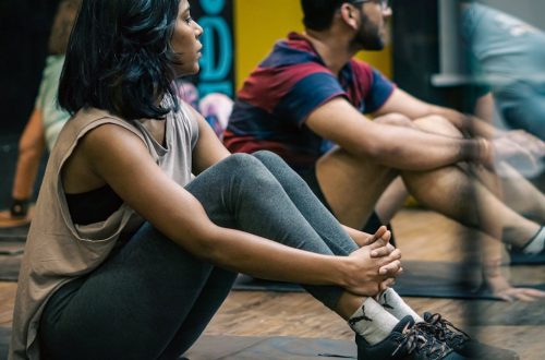 a group of people sitting on yoga mats
